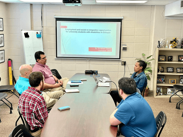 A group of people sitting at a conference table.